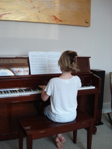 Mira practicing piano at home